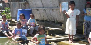 Schoolchildren hold up picture books from Books for the Barrios. (Photo/Courtesy of Dan Harrington)