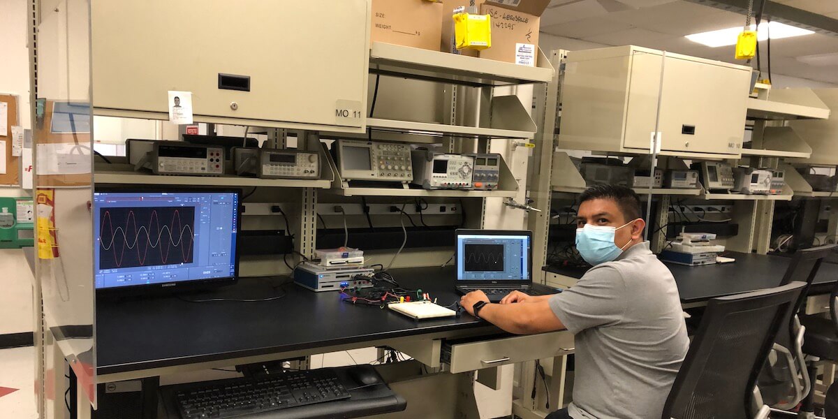 Senior Lab Technician Jeffrey Vargas models the new remote lab terminal set up, which allows TAs and students to connect to the same software remotely. PHOTO/ Charles Radovich.