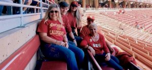 Three generations of a Trojan family in the bleachers at a USC football game