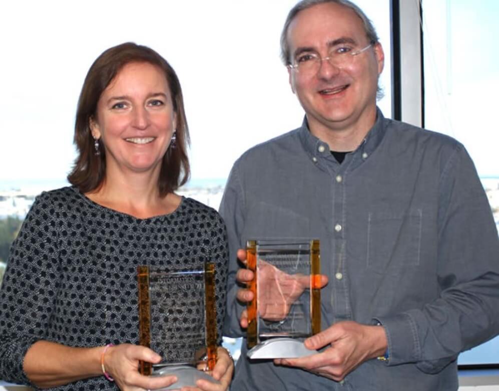 A photo of Ewa Deelman and John Heidemann holding their ISI Awards
