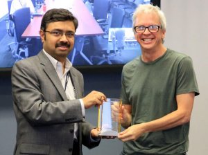 A photo of Prem Natarajan presenting an ISI award to Kevin Knight