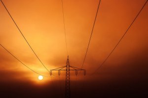picture of a power grid against a sunset backdrop