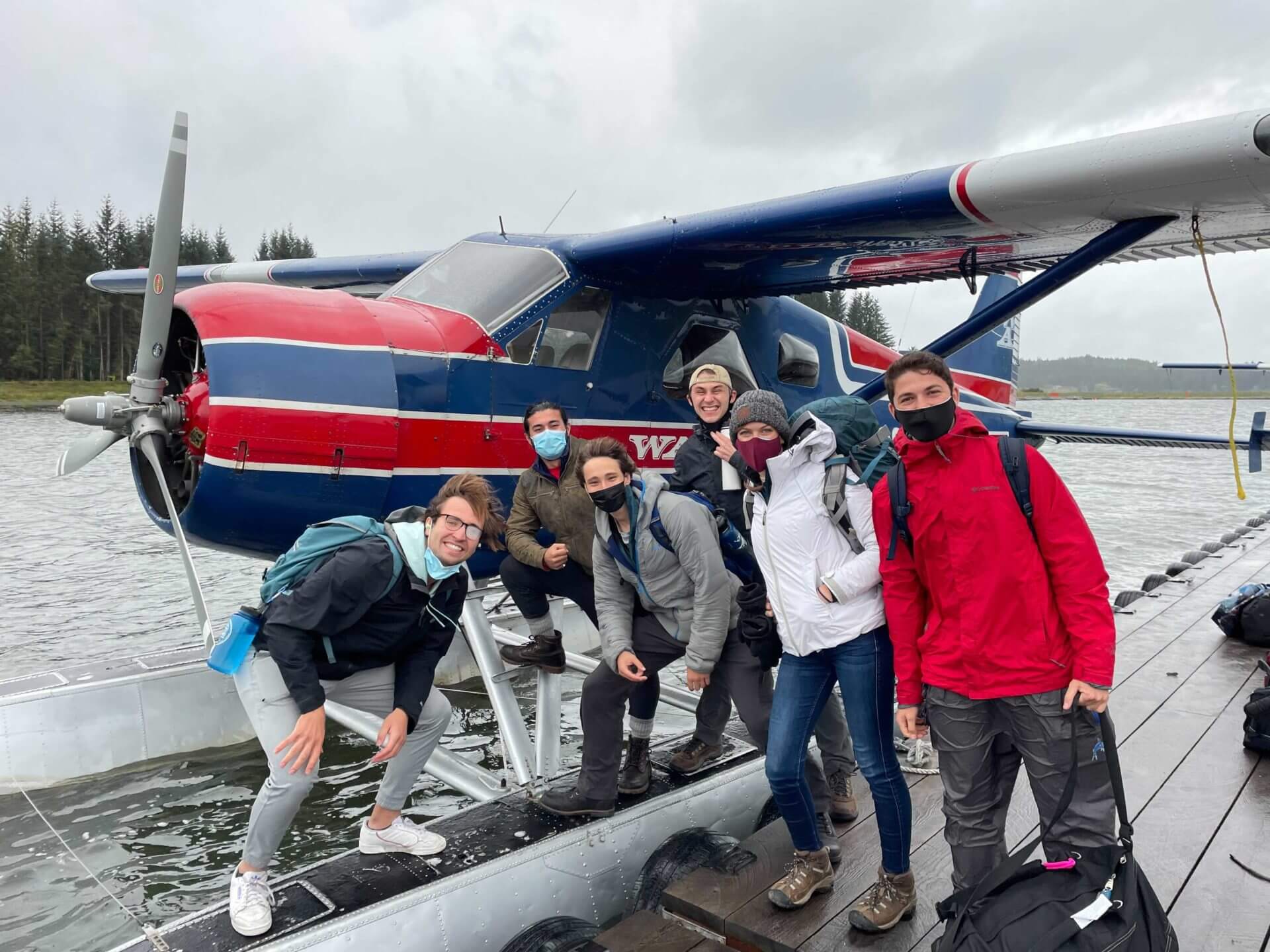 students in Hoonah Alaska, next to a prop plane