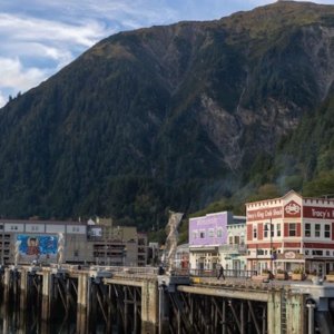 Hoonah Alaska landscape with mountains, businesses on shoreline, water