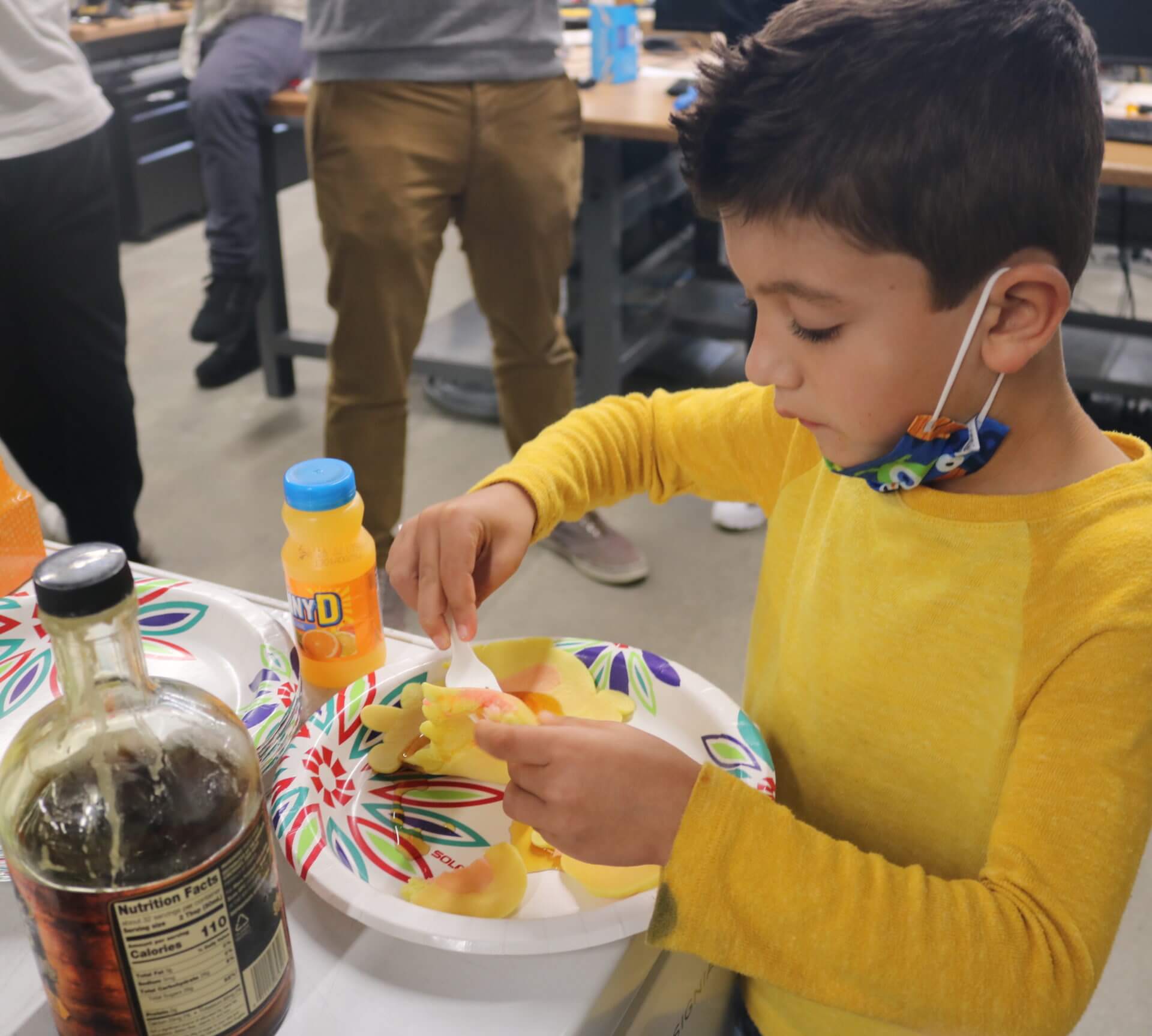 A young visitor enjoys a bunny-shaped pancake made by the Baxter robot. PHOTO/AVNI SHAH.