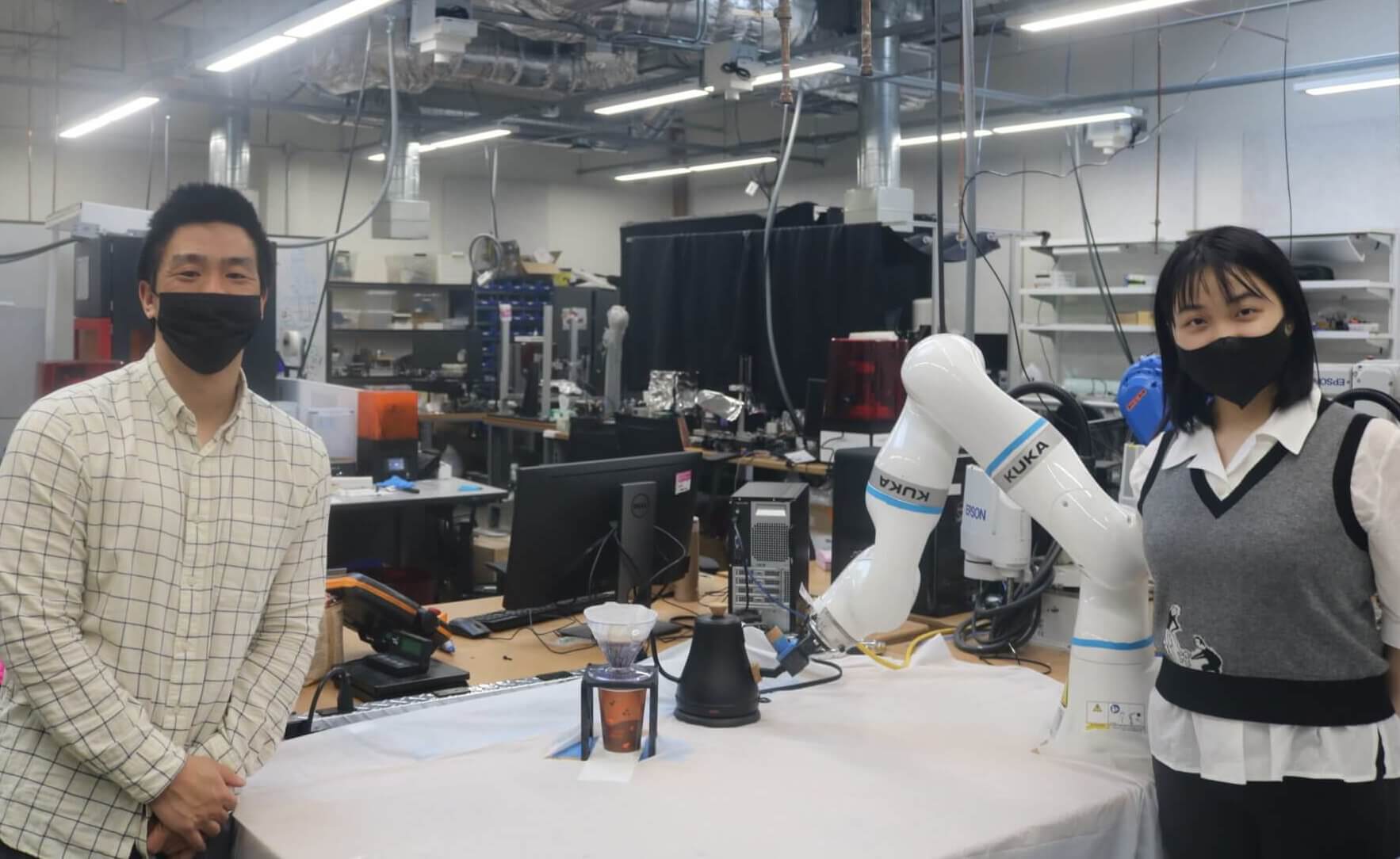 Master's students Anthony Tran and Yang Yang programmed a robot to make the perfect cup of pour-over coffee. 