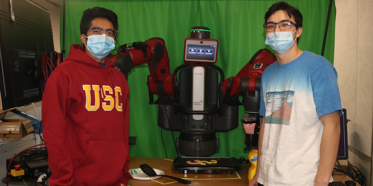 USC Viterbi students Vineeth Rajesh and Justin Lockwood make "SC" themed pancakes with the help of a Baxter robot. PHOTO/AVNI SHAH.