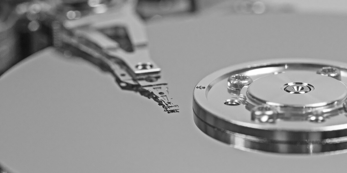 photo of inside of a hard drive, metal/ magnetism