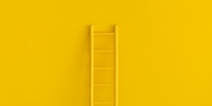 ladder on yellow wall