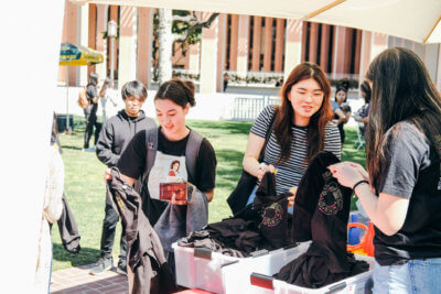 USC students take free ITP T-shirts at the program's anniversary party (Photo/Courtesy of ITP)