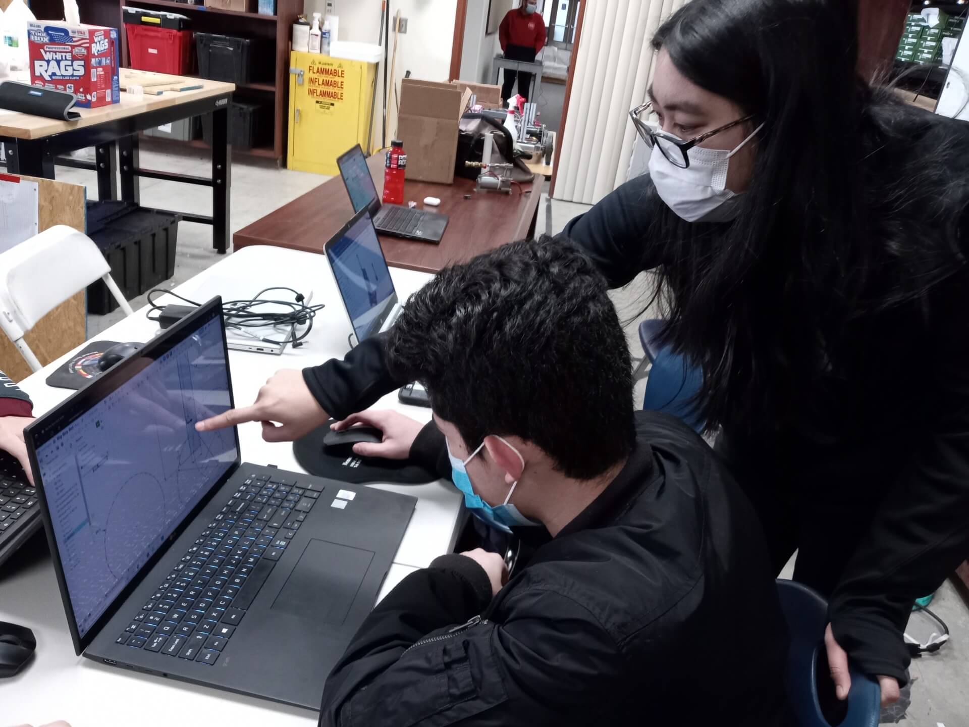 USC Viterbi student and FIRST Robotics mentor Joy Uehara helps student from Team 691 learn computer-aided design during their 2022 season. PHOTO/JOY UEHARA. 