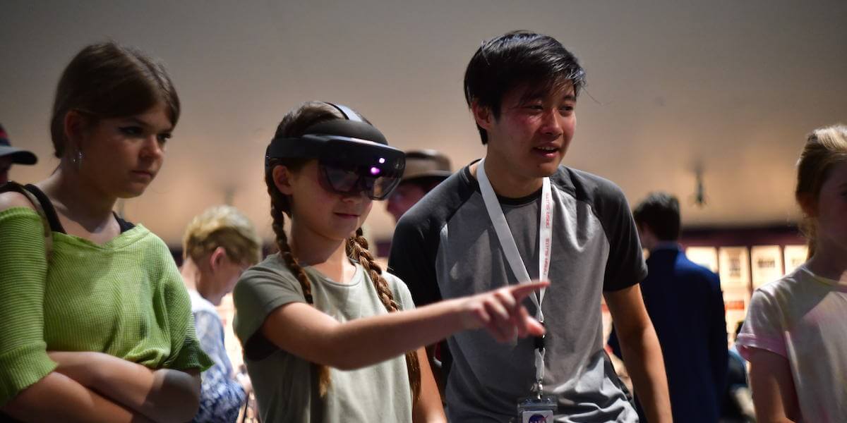 Lead Developer Spencer Lin oversees a visitor to Space Center Houston as they test out the S.E.N.V.A. application