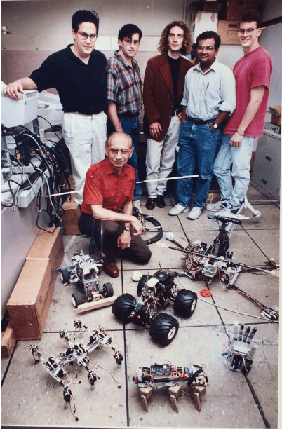 Bekey in the mid-90s with lab members. From left to right: Tony Lewis, Andy Fagg, Mathew Lamb, Gaurav Sukhatme, and David Lotspiech (PHOTO CREDIT: USC Viterbi)