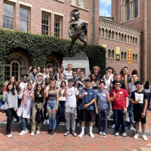 Sister2Sister Scholars (pictured on the far left) visited the Tommy Trojan statue with their fellow exchange students.