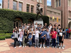 Sister2Sister Scholars (pictured on the far left) visited the Tommy Trojan statue with their fellow exchange students.