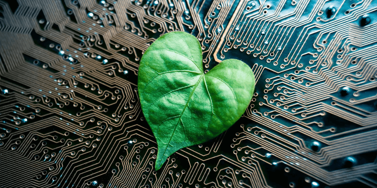 A heart-shaped green leaf on a computer circuit board