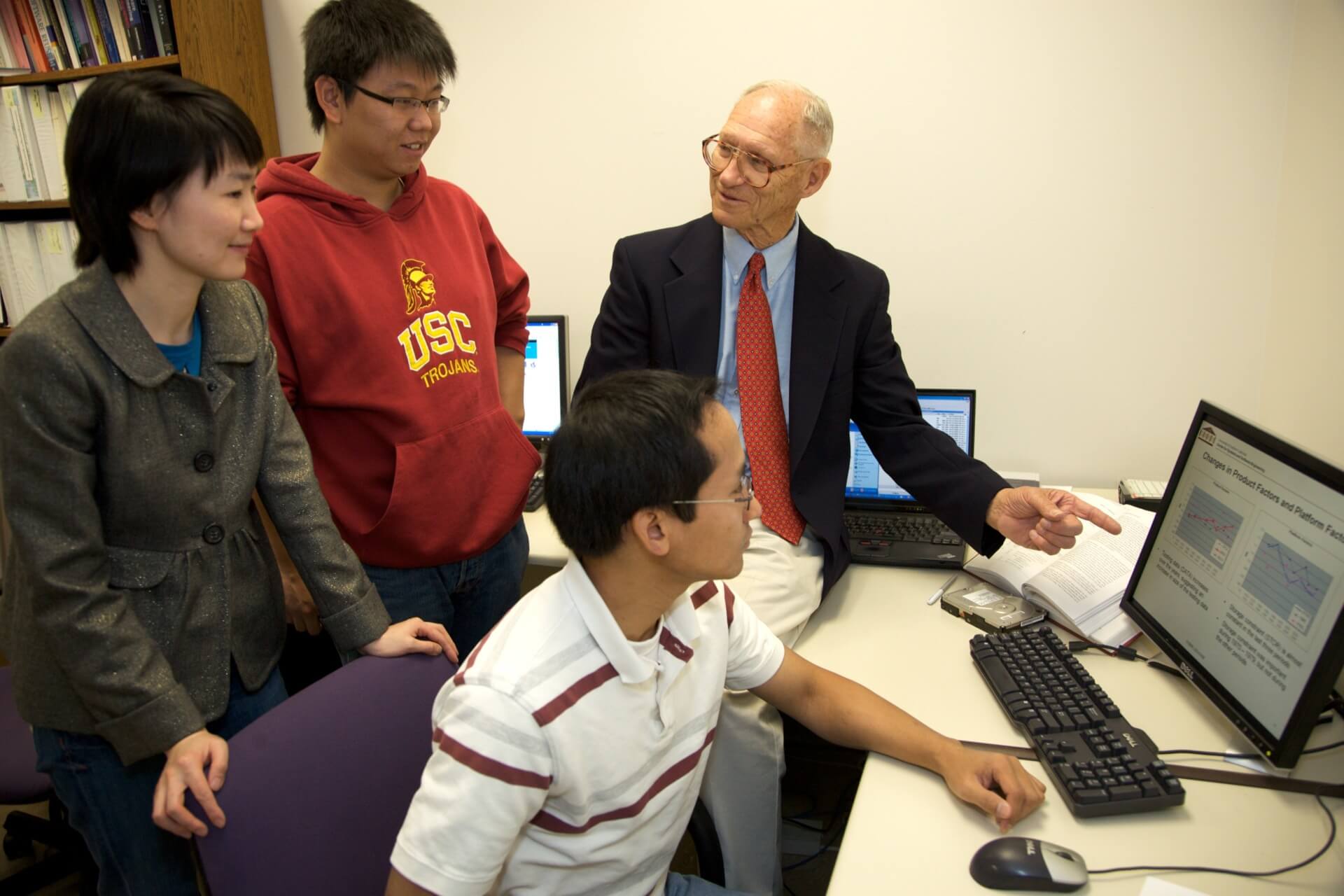 Professor Boehm works with CSSE PhD student Vu Nquyen '10, while Thomas Tan CSSE '11 and LiGuo Huang CSSE '06 watch on. (Photo/Jon Vidar)