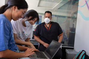 Frontida team setting up electronic medical record (EMR) system in field. PHOTO/Frontida Records.
