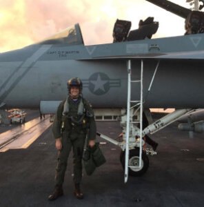 Retired U.S. Navy pilot Will Pressley next to fighter jet