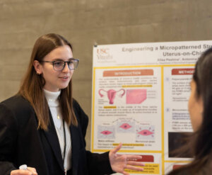 Top 1st Year award winner Alisa Peshina discusses her research at the Grodins Symposium. Image/Colin Huang
