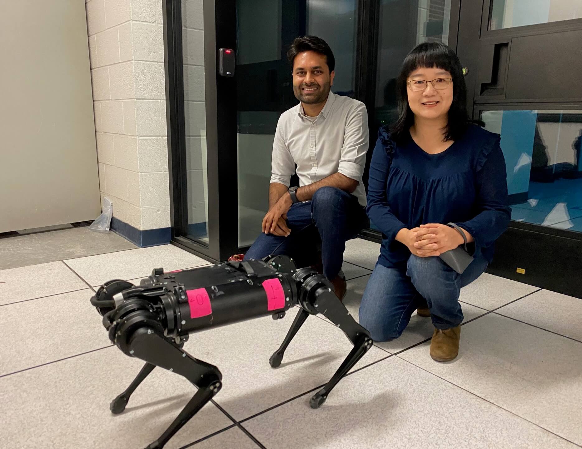 <em>Somil Bansal and Feifei Qian outside a lab in the basement of the Hughes Aircraft Electrical Engineering Center, where Prof. Qian programs legged robots to adjust to various terrain when walking. Her work and Prof. Bansal's robotics work share commonalities. (USC Photo/Landon Hall)</em>