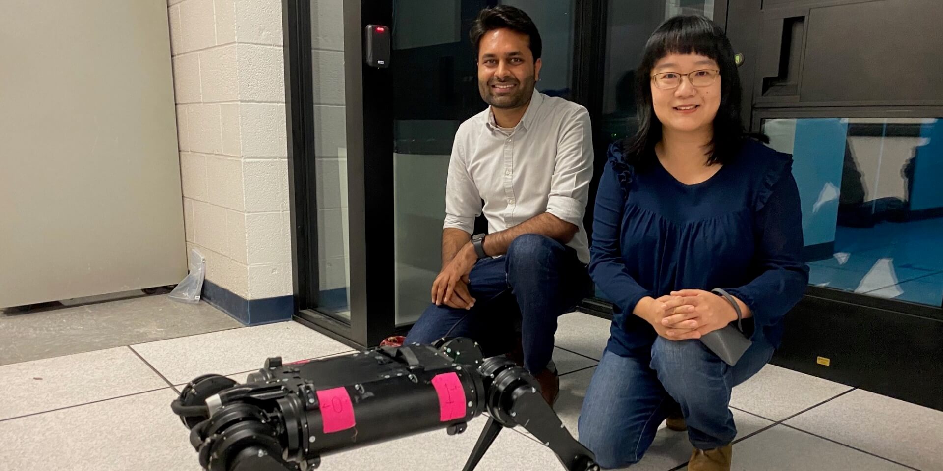 Somil Bansal and Feifei Qian outside a lab in the basement of the Hughes Aircraft Electrical Engineering Center, where Prof. Qian programs legged robots to adjust to various terrain when walking. Her work and Prof. Bansal's robotics work share commonalities. (USC Photo/Landon Hall)