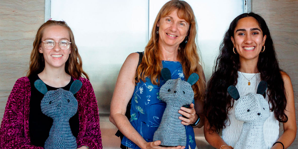 Professor Maja Matarić (center) and doctoral students Amy O’Connell (left) and Mina Kian (right) with a trio of Blossom robots. 