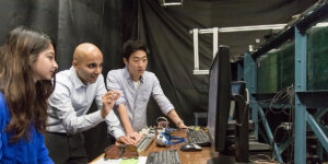 Luhar and students review experimental data from the Blue Water Channel.