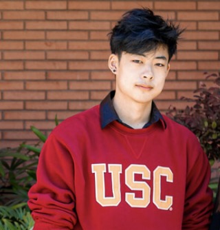 Allen Chang is pictured wearing a red USC sweater.