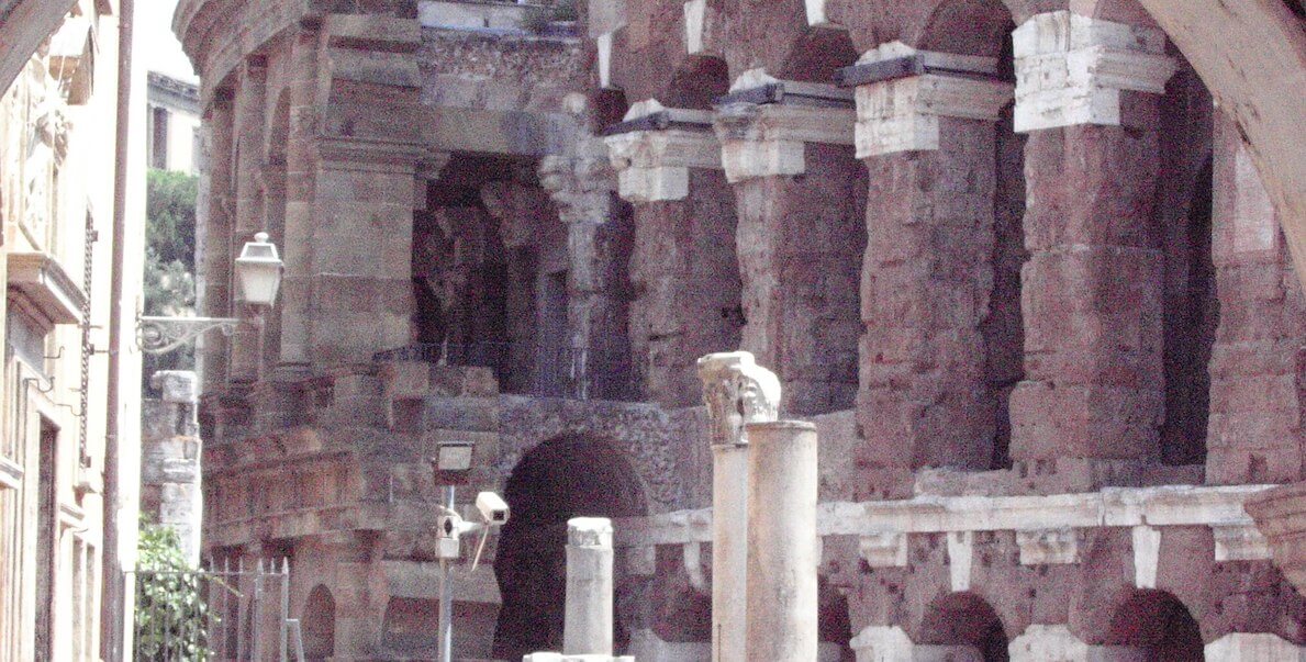 Close up of an ancient building in rome with arches.