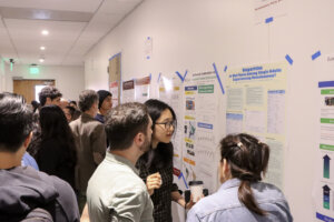 ShowCAIS 2024 attendees engage with research posters at the event