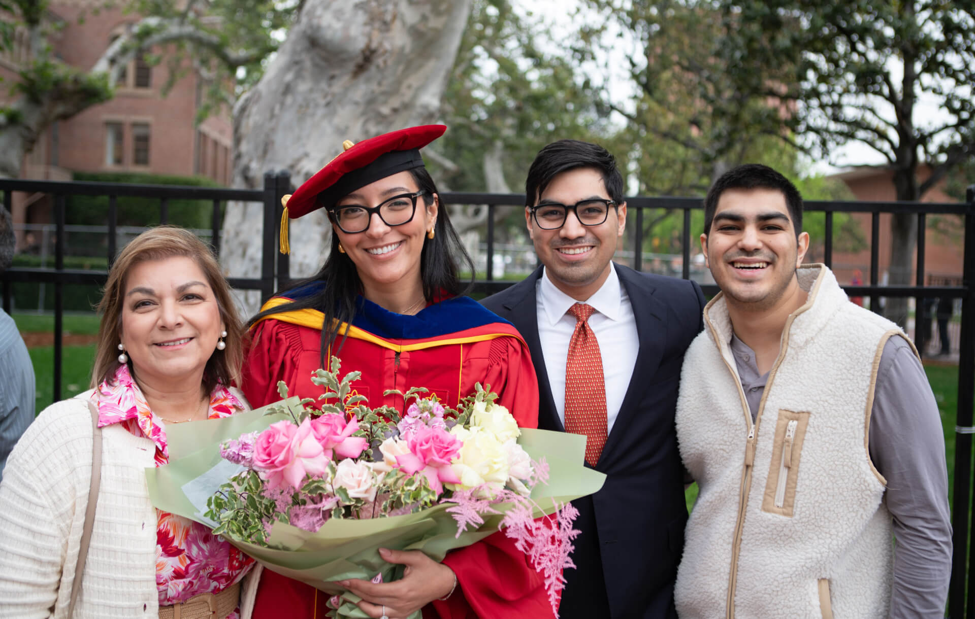 Hiba Kahouli, a new Ph.D. in aerospace and mechanical engineering, poses with family at USC Viterbi's 2024 Ph.D. Hooding and Awards event.