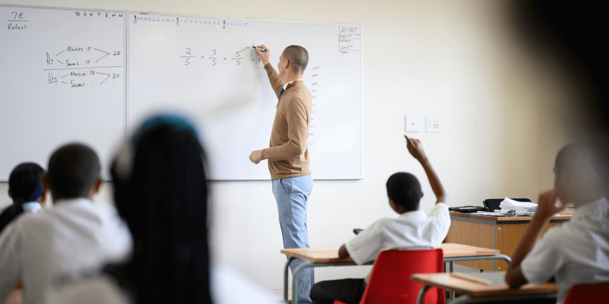 Teacher at a white board