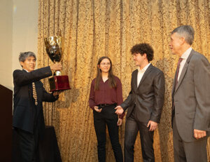 Kenneth Lui, Program Chair at AIAA Los Angeles Section, presents USCRPL's Ryan Kraemer and Jayna Rybner with award for the milestone launch of Aftershock II