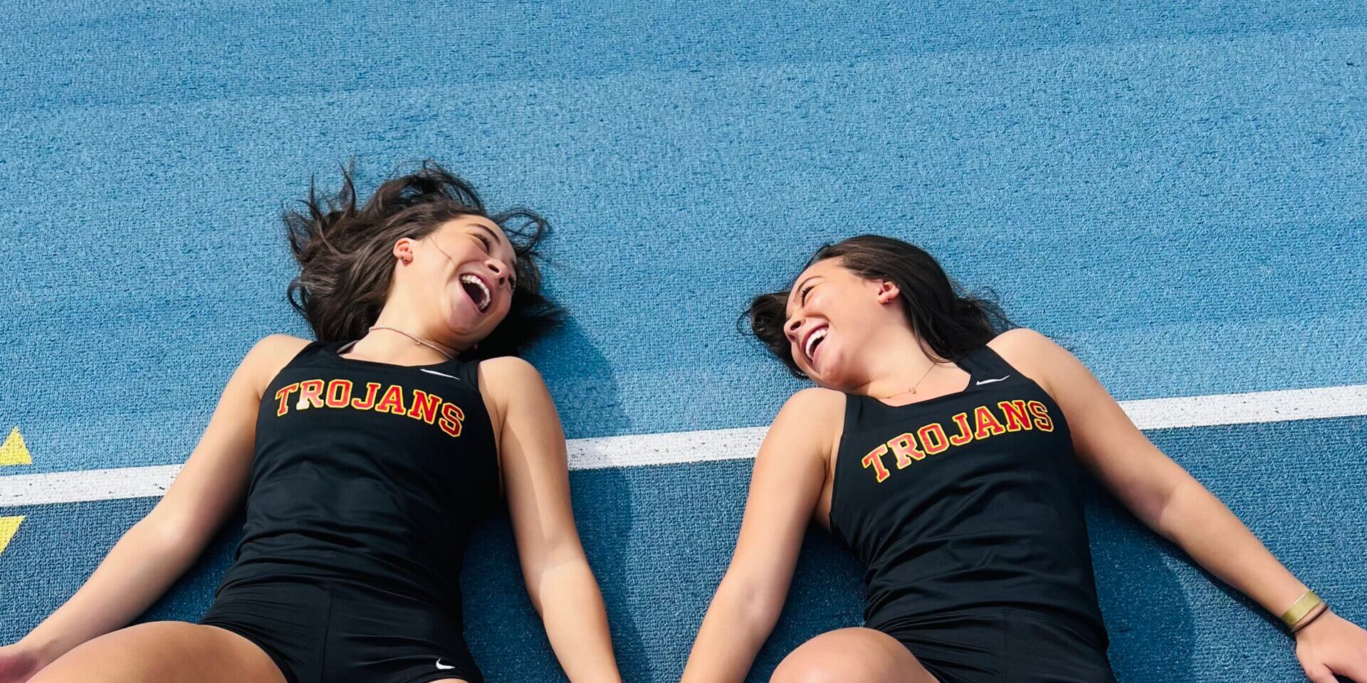 Twins Gabrielle and Zoe Edwards, both USC Viterbi students, share a laugh in their track attire (Photo/Courtesy of Gabrielle Edwards)