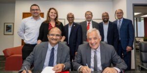 Dean Yortsos in front row along with BITS Pilani Administrator with BITs and USC Viterbi along with USC Vice President Anthony Bailey standing behind them as they sign an MOU