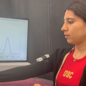 Michella Rustom demonstrates joint flexion using the wearable magnetic-induction-based sensors.