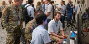 people huddled around a computer