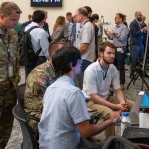 people hudled around computer